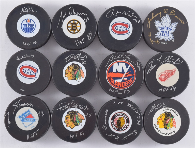 Hall of Fame Signed Goalie Puck Collection of 12 Including Giacomin, Francis and Hasek with LOA