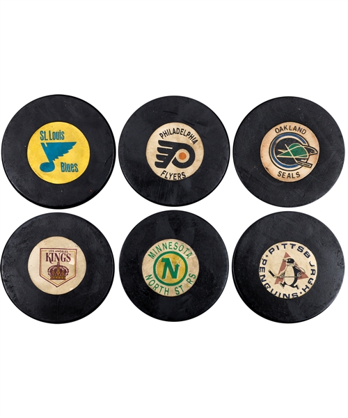 Paul Hendersons 1968-69 Art Ross / Converse NHL Expansions Teams Game Pucks (5) and 1969-76 Oakland Seals Art Ross / Converse Game Puck with His Signed LOA