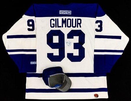 Doug Gilmour Signed Toronto Maple Leafs Captains Jersey (Signed Twice - JSA COA) and Morgan Rielly Signed Toronto Maple Leafs Reebok Team Draft Cap (NHL COA)